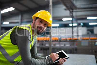 Factory worker using digital tablet