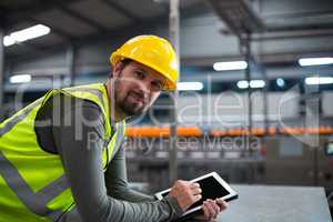 Factory worker using digital tablet