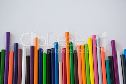 Colored pencils arranged in a wavy pattern
