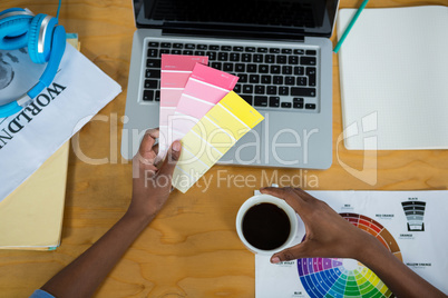 Female graphic designer holding color swatch