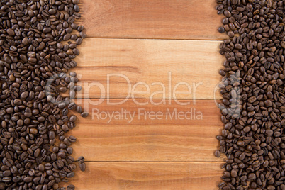 Coffee beans arranged on wooden table