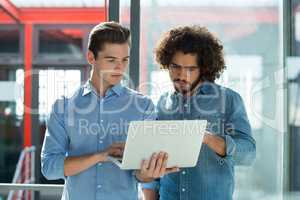 Two business executives working on laptop