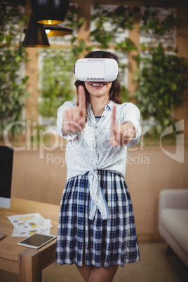 Female business executive using virtual reality headset