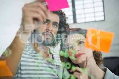 Thoughtful executives looking at sticky note