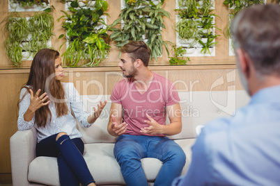 Couple arguing in counseling session with a doctor