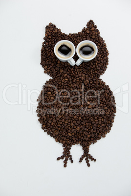 Coffee beans and cups forming owl