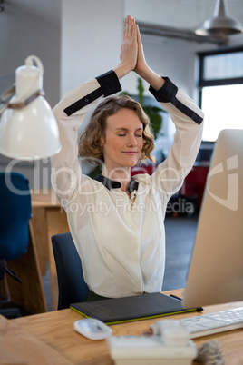 Female graphic designer performing yoga