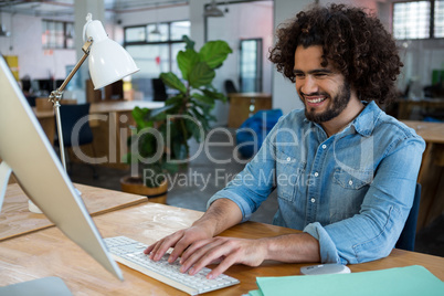 Male graphic designer working at desk