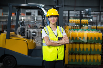 Portrait of female worker standing with arms crossed
