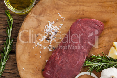Beef steak and ingredients on wooden board