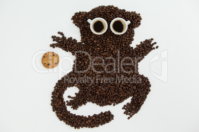 Coffee beans and cups forming monkey with cookie