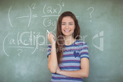 Portrait of schoolgirl pretending to be a teacher in classroom