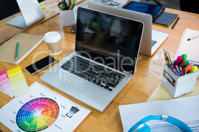 Laptop, color swatch and mobile phone on desk