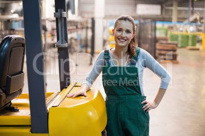 Female factory worker standing at drinks production factory