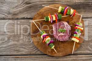 Sirloin chop with skewered vegetables on wooden tray