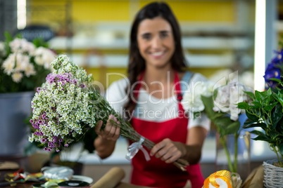 Florist offering flowers at the counter