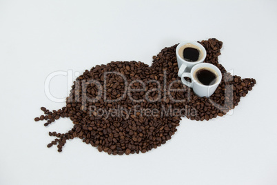Coffee beans and cups forming owl