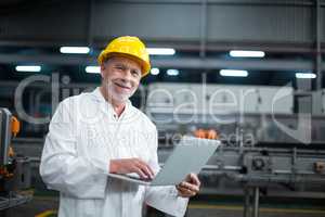 Factory engineer using laptop in the factory