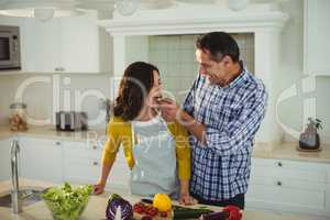 Man feeding woman in the kitchen