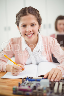 Schoolgirl working on electronic project in classroom