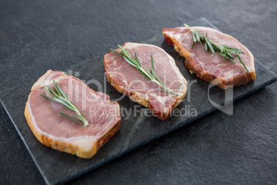 Sirloin chops and rosemary herb on slate plate