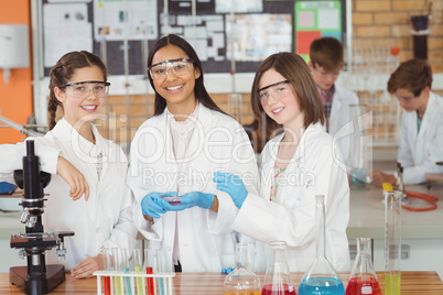 Portrait of schoolgirls doing a chemical experiment in laboratory