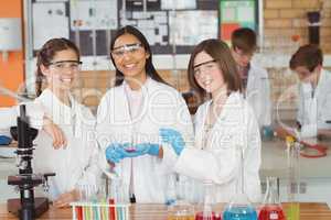 Portrait of schoolgirls doing a chemical experiment in laboratory