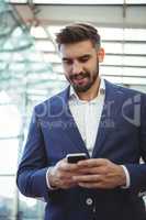 Attentive businessman using mobile phone