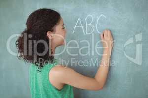 Schoolgirl pretending to be a teacher in classroom