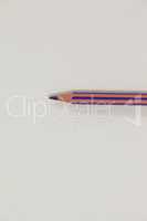 Purple colored pencil on white background