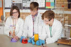 Schoolkids doing a chemical experiment in laboratory