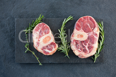 Sirloin chops and rosemary herb on slate plate