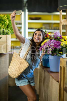 Woman taking a selfie at florist shop