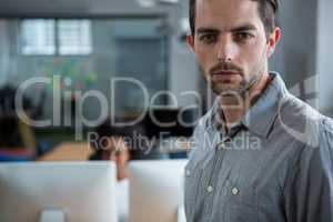 Serious man standing in office