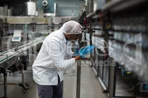 Factory engineer counting bottles