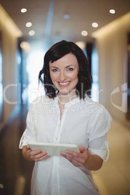 Portrait of female executive holding digital tablet