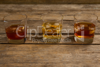 Three glasses of whiskey with ice cube