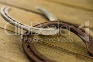 Two horseshoes on wooden surface