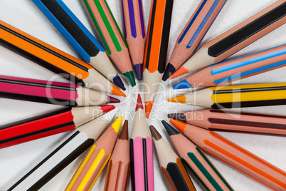 Close-up of colored pencils arranged in a circle