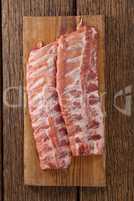 Beef ribs on wooden board