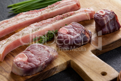 Sirloin chops and beef steak on wooden board