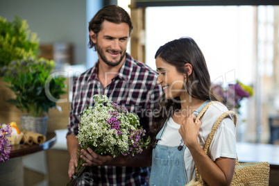 Couple selecting flowers in the florist shop