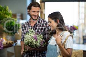 Couple selecting flowers in the florist shop