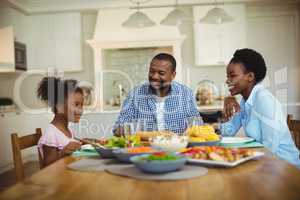 Family having meal on dinning table at home