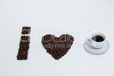 Coffee beans and cups forming I love, addiction coffee