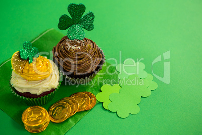 St Patricks Day shamrock on the cupcake with gold coins