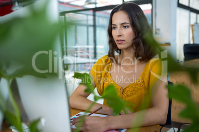 Female graphic designer working on computer