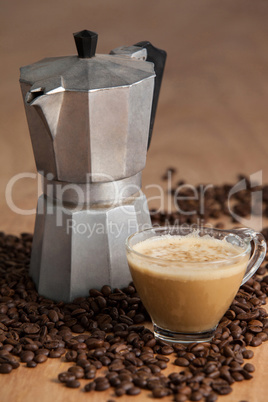 Coffee beans with metallic coffee maker and coffee cup