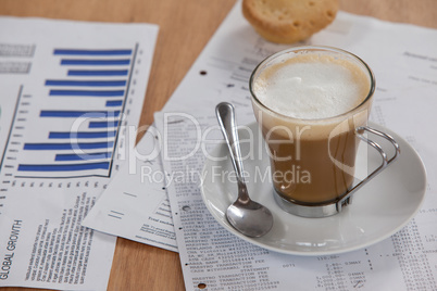 Coffee cup with saucer, spoon and documents