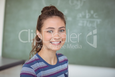 Portrait of happy schoolgirl in classroom